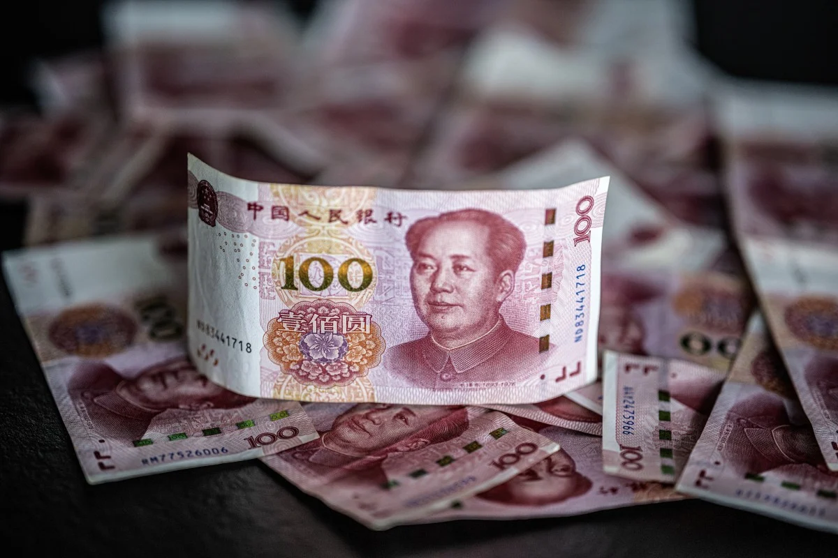 Yuan reaches 15 month high as central bank sets stronger fixing amid offshore gains